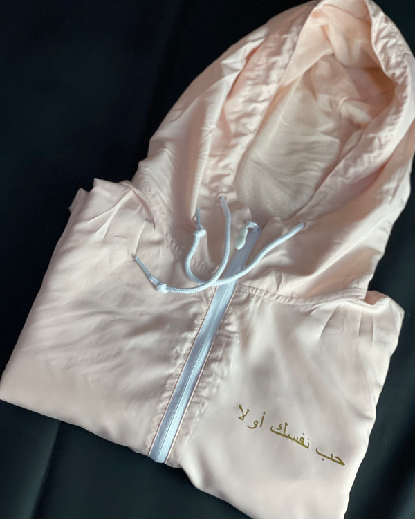 Love Yourself First Arabic Blush Windbreaker. Lightweight, water resistant, wind resistant.